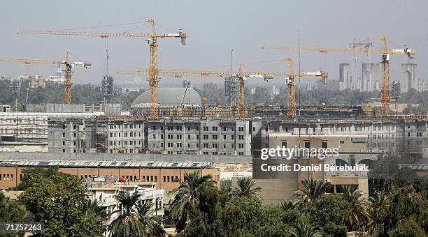 Cranes litter the skyline as construction workers continue work on the new United States Embassy compound in Baghdad's fortified Green Zone on August...