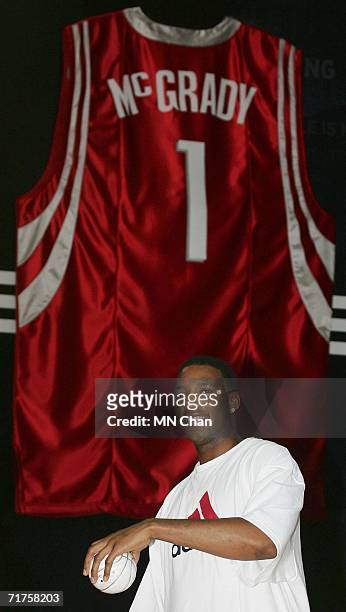 Player Tracy McGrady of the Houston Rockets throws balls out to the fans during a ceremony to launch an Adidas shoe at his second visit to Hong Kong...