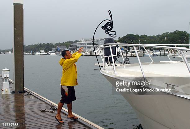 John Riggs helps a boat owner move to safer harbor in preperation for approaching Tropical Storm Ernesto August 31, in Wrightsville Beach, North...