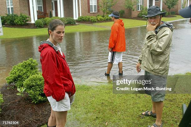 Neighbors watch the waters rise as Tropical Storm Ernesto approaches August 31, 2006 in Wilmington, North Carolina. Ernesto picked up speed in the...
