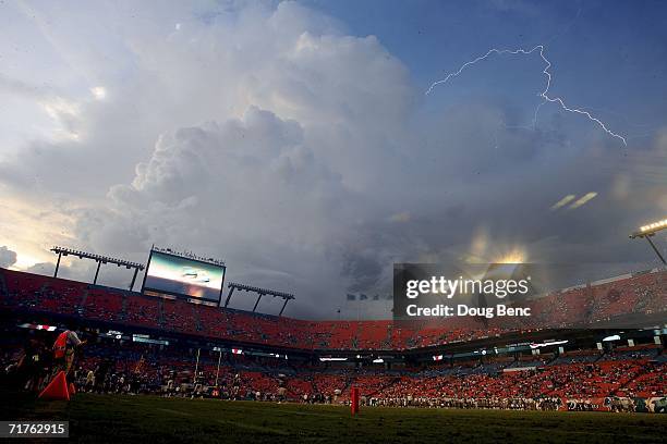 Remnants of tropical storm Ernesto cause a lightning storm during the game as the Miami Dolphins take on the St. Louis Rams at Dolphin Stadium during...