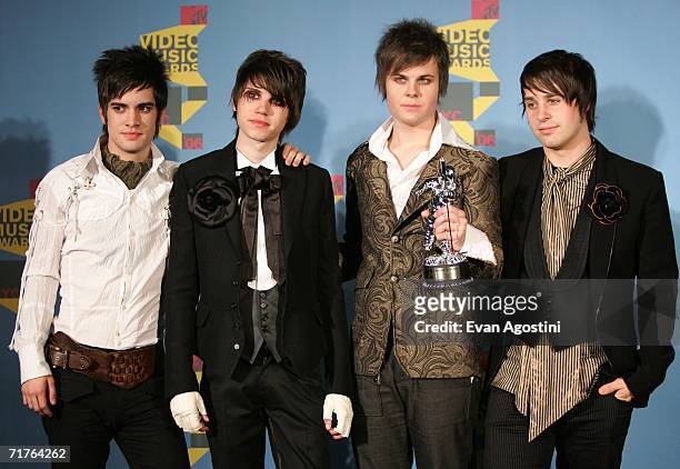 Musicians Brendon Urie, Ryan Ross, Spencer Smith and Jon Walker of Panic! At The Disco pose in the press room with their award for "Video of the...