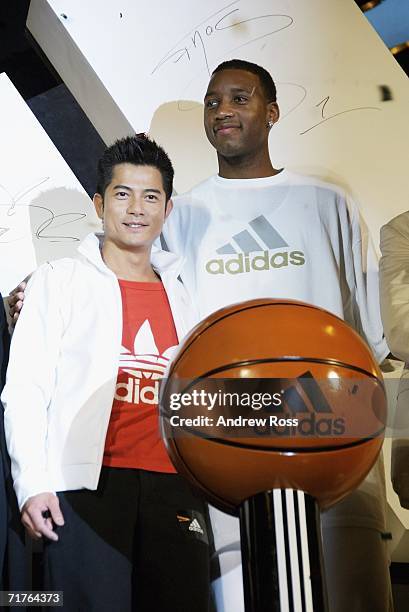 Singer Aaron Kwok and NBA player Tracy McGrady of the Houston Rockets attend the launch of new adidas shop in Tsim Tsa Tsui on August 31, 2006. In...