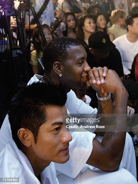Singer Aaron Kwok and NBA player Tracy McGrady of the Houston Rockets attend the launch of new adidas shop in Tsim Tsa Tsui on August 31, 2006. In...