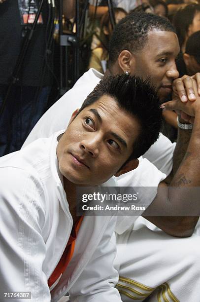 Singer Aaron Kwok and NBA player Tracy McGrady of the Houston Rockets attend the launch of new adidas shop in Tsim Tsa Tsui on August 31, 2006. In...