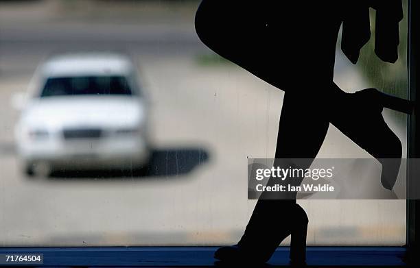 Beth, a "service provider" at Sydney brothel The Site, stands in a window as a motorist approaches September 1, 2006 in Sydney, Australia. The...
