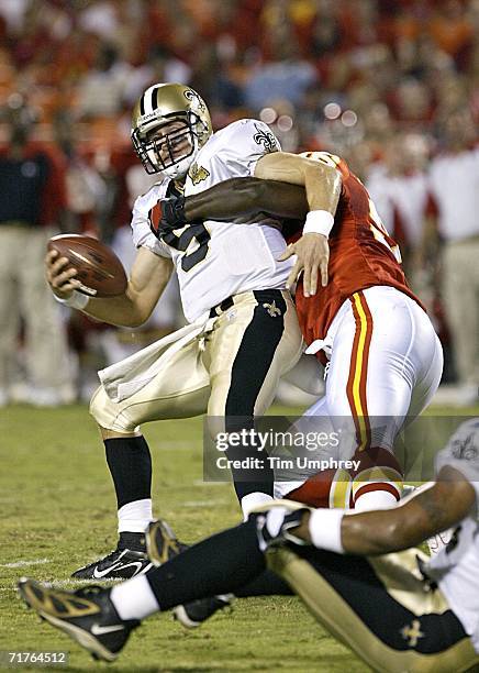 Quarterback Drew Brees of the New Orleans Saints is sacked by defensive end Jimmy Wilkerson of the Kansas City Chiefs in a preseason game at...