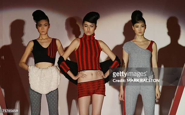 Models wear knitwear designed by local Chinese designers for the German fashion label Stoll at a fashion show in Shanghai 01 September 2006. Chinese...