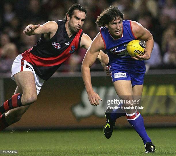 Ryan Griffin for the Bulldogs runs off Scott Lucas for Essendon during the round 22 AFL match between the Western Bulldogs and the Essendon Bombers...