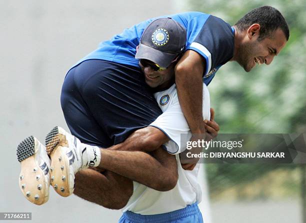 Indian cricketer Mohammed Kaif enjoys a light moment with teammate Irfan Pathan during a practice session at the National Cricket Academy in...