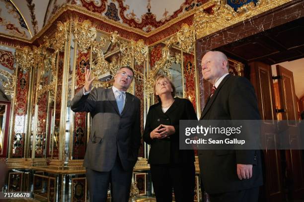 German Chancellor Angela Merkel and Governor of Saxony Georg Milbradt tour exhibits at the Gruenes Gewoelbe Museum with museum director Dirk Syndram,...