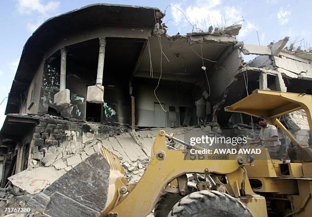 Workers clear the rubble in a neighbourhood destroyed by Israeli bombing during the 34-day anti-Hezbollah offensive in the southern village of Bint...