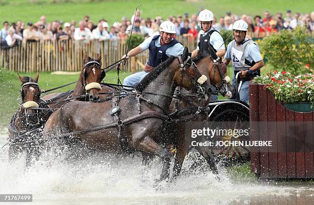 Michael Freund and his co-drivers of Germany take part in the Four-in-Hand Driving marathon competition of the World Equestrian Games in Aachen 01...