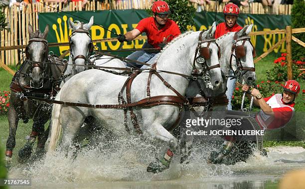 Jozsef Dobrovitz and his co-drivers of Hungary take part in the Four-in-Hand Driving marathon competition of the World Equestrian Games in Aachen 01...