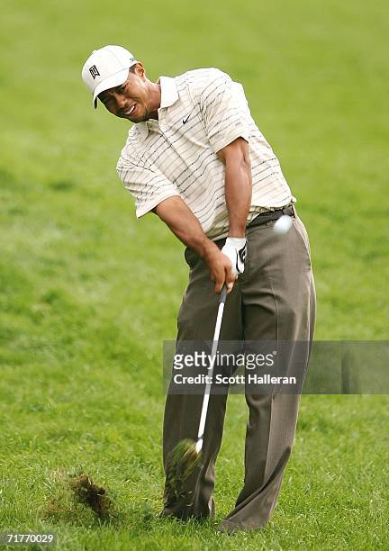 Tiger Woods hits a shot from the rough on the 15th hole during the first round of the Deutsche Bank Championship at the TPC of Boston on September 1,...