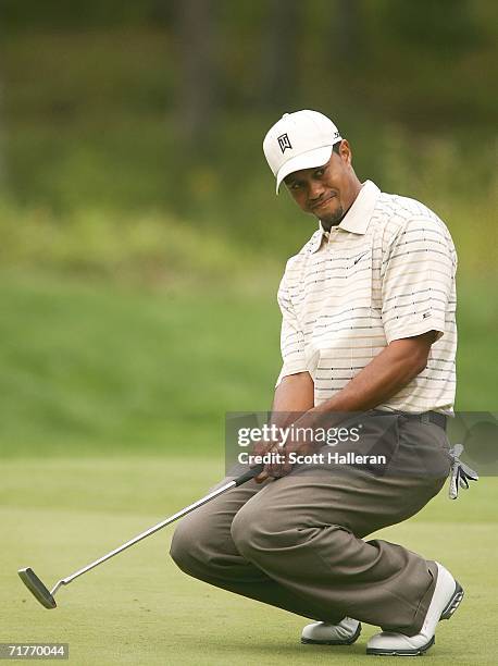 Tiger Woods reacts to a missed putt on the 17th green during the first round of the Deutsche Bank Championship at the TPC of Boston on September 1,...