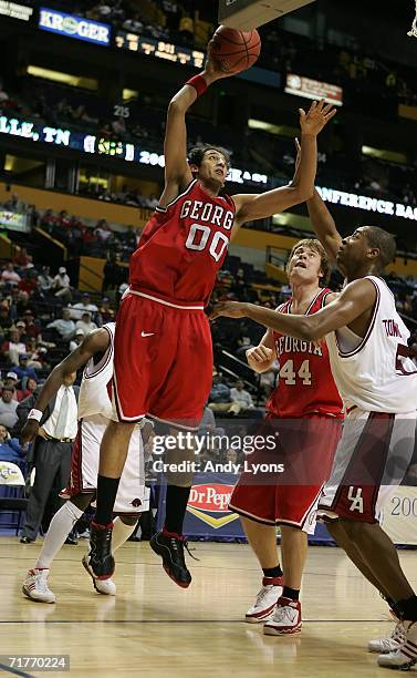 Younes Idrissi of the Georgia Bulldogs attempts a shot against Darian Townes of the Arkansas Razorbacks during day 1 of the SEC Men's Basketball...