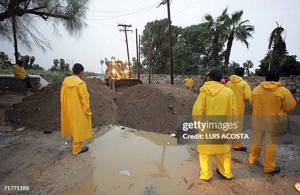 Truck sets up a barricade to prevent possible floods before the arrival of Hurricane John, at San Jose de los Cabos, Baja California, northwest of...