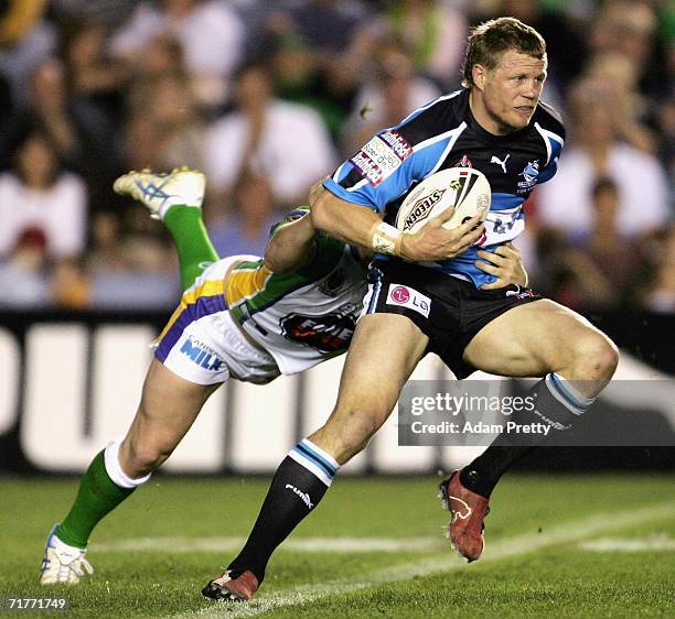 Darren Albert of the Sharks is tackled during the round 26 NRL match between the Cronulla-Sutherland Sharks and the Canberra Raiders at Toyota Park...