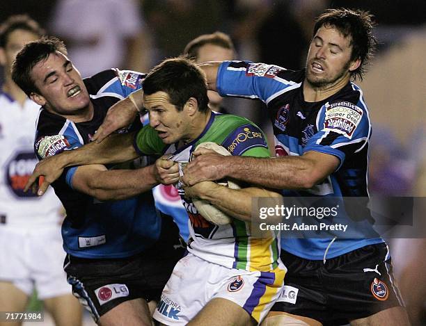 Clinton Schifcofske of the Raiders is tackled during the round 26 NRL match between the Cronulla-Sutherland Sharks and the Canberra Raiders at Toyota...