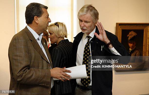 Lappeenranta, FINLAND: Cypriot Foreign Minister Yiorgos Lillikas chats with his Finnish counterpart Erkki Tuomioja prior a working session of the...