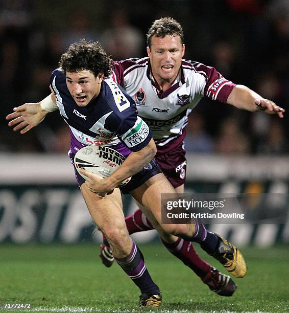 Billy Slater of the Storm is chased by Matt Orford of the Sea Eagles during the round 26 NRL match between the Melbourne Storm and the Manly...
