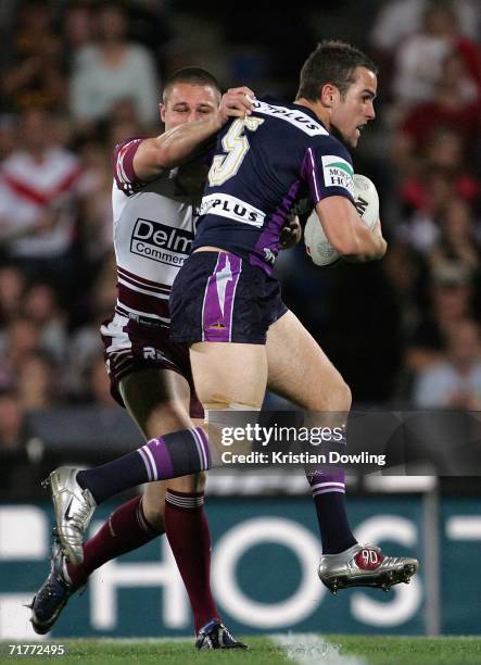 Steve Turner of the Storm is tackled during the round 26 NRL match between the Melbourne Storm and the Manly Warringah Sea Eagles at Olympic Park...