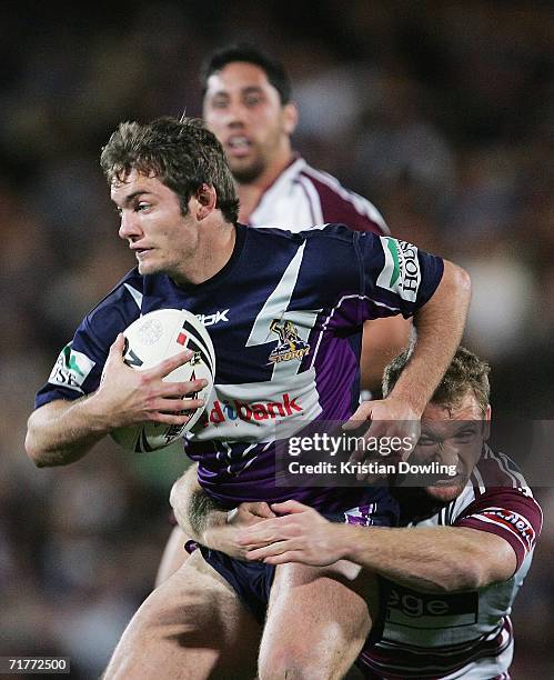 Dallas Johnson of the Storm is tackled by Michael Monaghan of the Sea Eagles during the round 26 NRL match between the Melbourne Storm and the Manly...