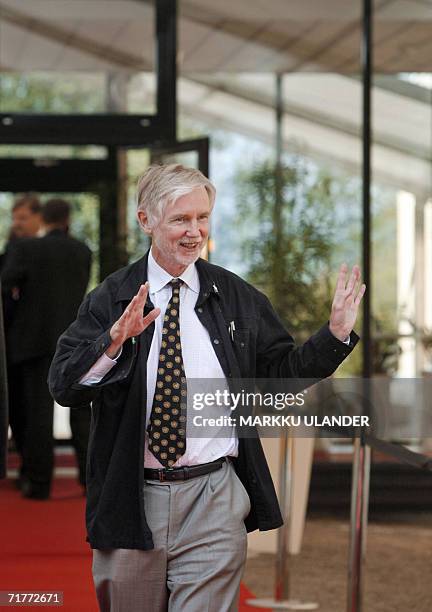 Lappeenranta , FINLAND: Finnish Foreign Minister and current chairman of the EU Council, Erkki Tuomioja, waves to the crowd as he leaves a working...