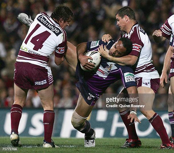 David Kidwell of the Storm is tackled by Shayne Dunley of the Sea Eagles during the round 26 NRL match between the Melbourne Storm and the Manly...