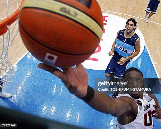 Dwyane Wade of the US lays up for a basket as Argentine Luis Scola looks on during their third place playoff match at the World Basketball...