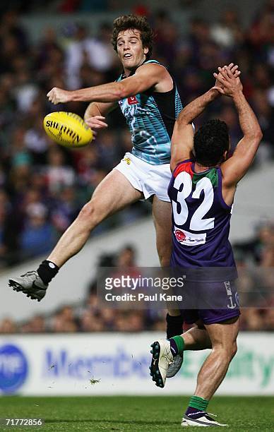 Greg Bentley of the Power punches the ball clear during the round 22 AFL match between the Fremantle Dockers and the Port Adelaide Power at Subiaco...