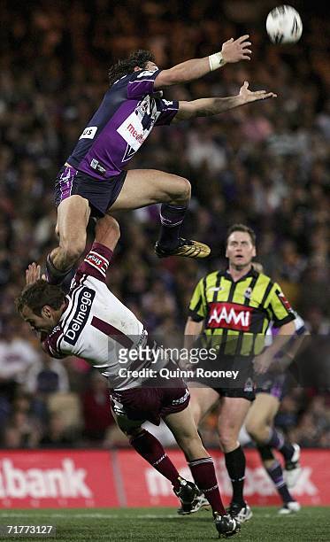 Billy Slater of the Storm flies high over the top of Brett Stewart of the Sea Eagles during the round 26 NRL match between the Melbourne Storm and...