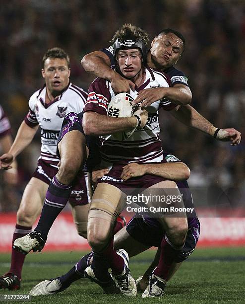 Steve Menzies of the Sea Eagles is tackled by David Kidwell of the Storm during the round 26 NRL match between the Melbourne Storm and the Manly...