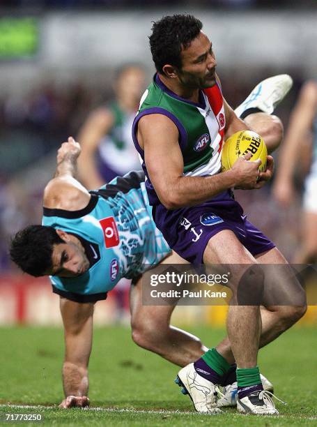 Peter Bell of the Dockers marks the ball ahead of Domenic Cassisi of the Power during the round 22 AFL match between the Fremantle Dockers and the...