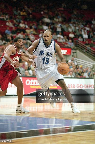 John Amaechi of the Orlando Magic moves with the ball against Jim Johnson of the Atlanta Hawks during the pre-season game at the TD Waterhouse Arena...