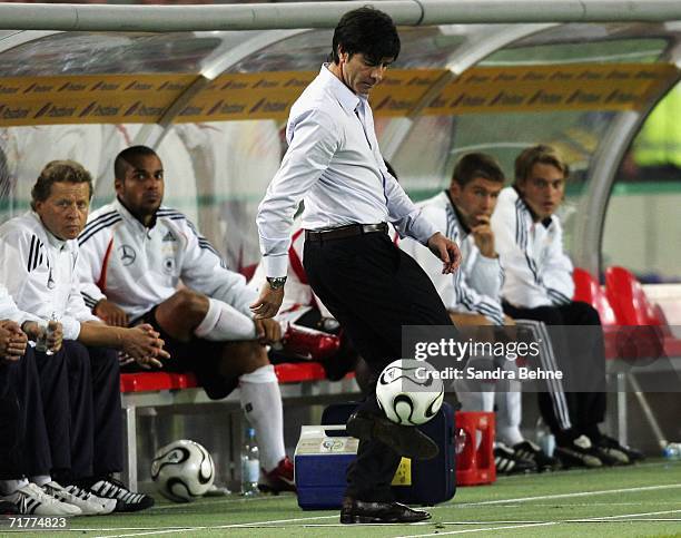 Coach Joachim Loew of Germany plays with the ball during the Euro 2008 qualifying match between Germany and the Republic of Ireland at the...