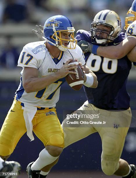 Quarterback Adam Tafralis of the San Jose State Spartans scrambles against Daniel Te'o Nesheim of the Washington Huskies on September 2, 2006 at...