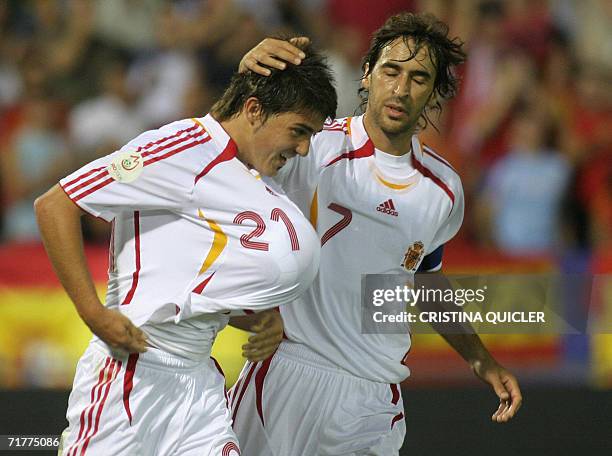 Spain's David Villa celebrates after scoring against Liechtenstein with captain Raul Gonzalez during a Euro2008 qualifying match at the Nuevo Vivero...