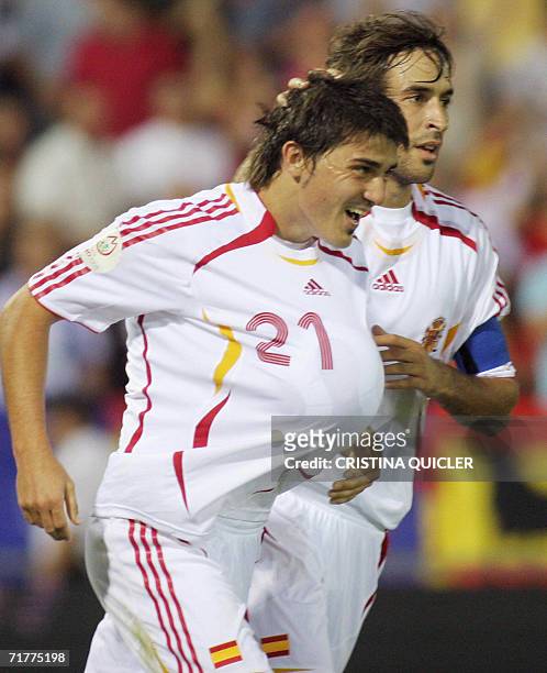 Spain's David Villa celebrates after scoring against Liechtenstein with captain Raul Gonzalez during a Euro2008 qualifying match at the Nuevo Vivero...