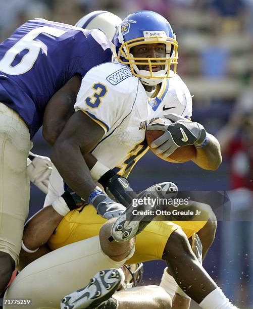 Wide receiver James Jones of the San Jose State Spartans is tackled by Matt Fountaine and Scott White of the Washington Huskies at Husky Stadium...