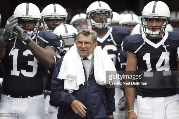 Head coach Joe Paterno walks onto the field with Defensive Tackle Jay Alford and Quarterback Anthony Morelli of the Penn State Nittany Lions prior to...