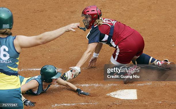 Stacey Nuveman of USA tags Simmone Morrow of Australia as she runs home during ISF XI Women's Fast Pitch Softball World Championship at the Fengtai...