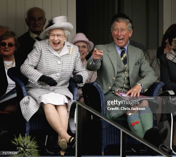 Queen Elizabeth II and Prince Charles, The Prince of Wales laugh as they watch competitors during the Braemar Gathering at the Princess Royal and...