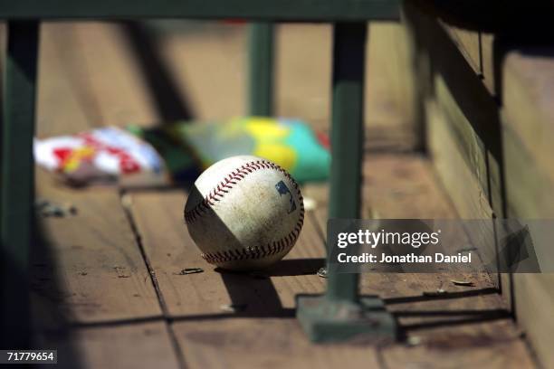 Baseball rests in the Milwaukee Brewers dugout next to a bag of sunflower seeds during a game between the Brewers and the Florida Marlins September...