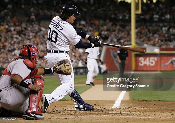 Magglio Ordonez of the Detroit Tigers hits a third inning RBI in front of Jose Molina of the Los Angeles Angels of Anaheim on September 3, 2006 at...