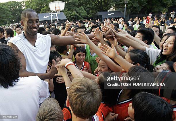 S Los Angeles Lakers' star shooting guard Kobe Bryant is greeted by junior basketball players during his basketball clinic, "Kobe81 Asia Tour Summer...