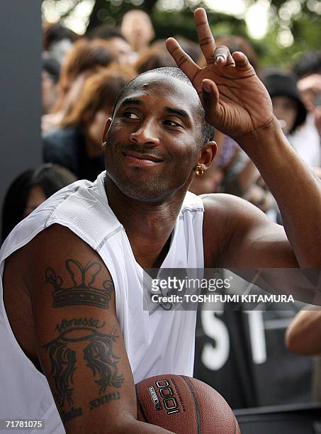 S Los Angeles Lakers star shooting guard Kobe Bryant flashes a victory sign to his fans during his talk show as part of his basketball clinic,...