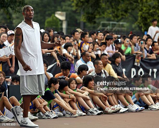 S Los Angeles Lakers star shooting guard Kobe Bryant watches a game played by junior basketball players during his basketball clinic, "Kobe81 Asia...