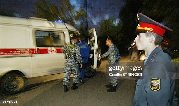 Moscow, RUSSIAN FEDERATION: A policeman stands guard as two soldiers of special police forces search an ambulance near the prison in the southeastern...
